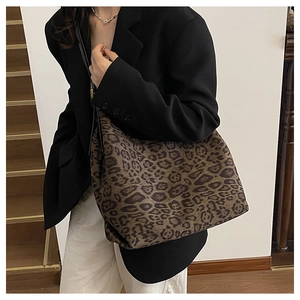 Close-up of leopard print tote bag featuring large capacity and black shoulder strap