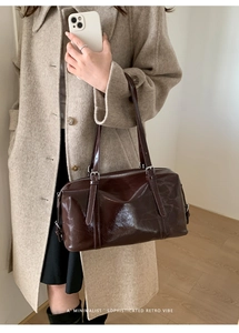 Deep brown glossy oil wax leather pillow bag featuring high-shine finish and retro vibe