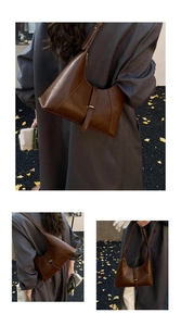 Macro detail of dark brown vintage leather shoulder bag with gold buckles and chic texture
