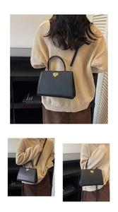 Détail du cabas vintage en cuir noir avec fermoir doré géométrique et poignée supérieure