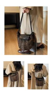 Three-way view of leopard print bucket bag with black leather flap on beige coat