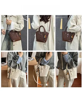 Detail view of quilted leather crossbody bags in brown and beige with beaded accents
