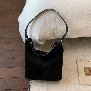 Detailed view of the large black suede hobo bag with vintage texture and adjustable strap