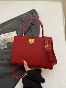 Red retro leather handbag with gold buckle and adjustable strap for casual daily use