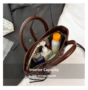 Top view of dark brown woven handbag showing large capacity with internal zipper pocket