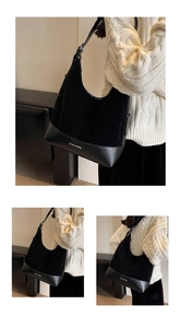 Detail of black suede tote bag with CLEARWN lettering and adjustable metal buckle
