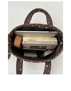 Internal view of a brown polka dot tote bag showing a large capacity for tablets and books