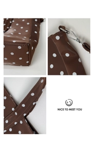 Detailed views of brown polka dot tote bag with silver hardware and reinforced straps