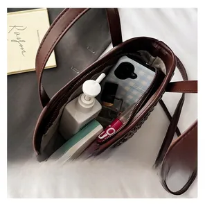 Interior view of brown woven bucket bag showing large capacity for daily essentials