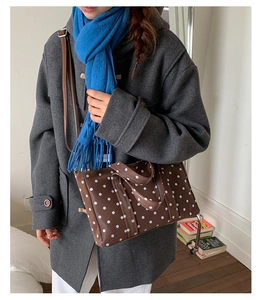 Polka dot tote bag styled with grey wool coat and blue scarf for daily commute