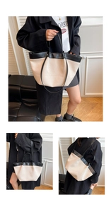 Detail of canvas tote bag with black leather stitching and large capacity interior