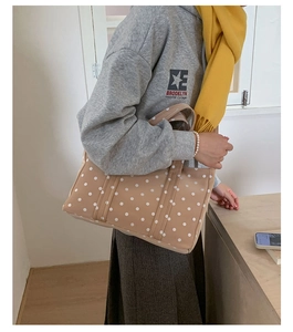 Close-up of khaki polka dot tote bag with sturdy double handles for daily commute
