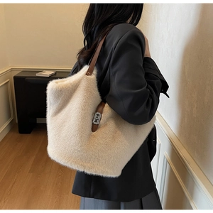 Detail of plush tote bag showing soft faux fur texture and leather strap with metal buckle