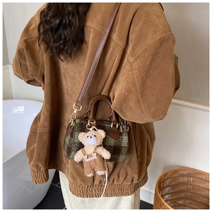 Detail of Boston plaid handbag in green and brown with a cute bear plush charm