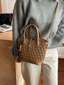 Brown quilted embossed crossbody handbag for women with adjustable strap and beaded charm