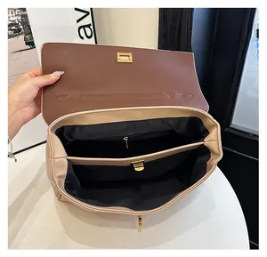 Detail view of the beige leather bag interior with brown flap and multi-compartment lining