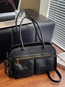 Versatile black multi-pocket tote bag with dual straps and utility cargo design details