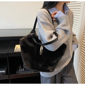Detail of black faux fur tote bag showing plush texture and silver metal buckle closure