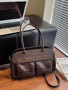 Brown faux leather multi-pocket tote bag shown with office essentials for work