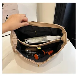 Interior view of soft khaki tote showing multiple compartments and zipper pocket details