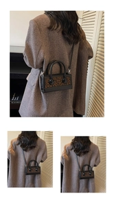 Detailed look at leopard print crossbody bag with dual ring handles on wool coat