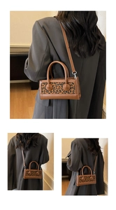 Detail of vintage leopard print handbag with brown leather panel and adjustable strap