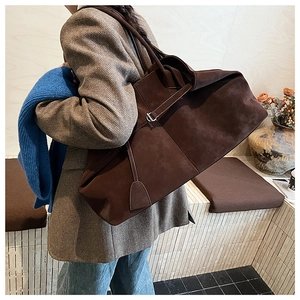 Close-up of high-quality dark brown suede texture on a minimalist large tote bag