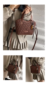 Detail of brown pleated bucket bag with quilted texture and wooden bead charm accessory