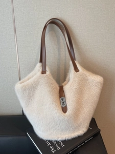 Large beige plush tote bag with brown leather straps and metal turn-lock for women