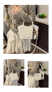 Detail of white wave-quilted bucket bag featuring a unique wooden bead charm and crossbody strap