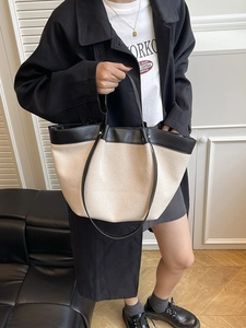 Canvas and leather patchwork tote bag for women showing a large capacity wing-shaped design