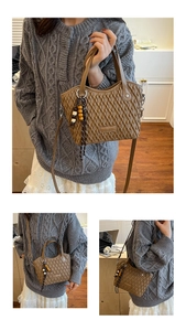 Detail of a brown woven bucket bag with quilted texture and a decorative beaded charm