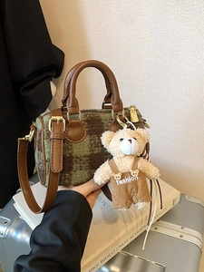 Chic green plaid Boston handbag with leather handles and cute plush bear charm