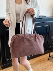 Brown suede Boston tote bag with large capacity, worn by model in minimalist setting