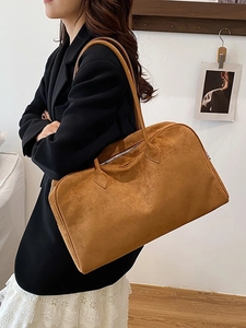 Brown suede Boston tote bag with large capacity shown in a stylish autumn commute outfit