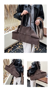 Detail of dark brown suede tote bag with slim straps and metal buckle decoration