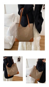 Detail of khaki fabric and brown leather splicing on a large capacity tote bag