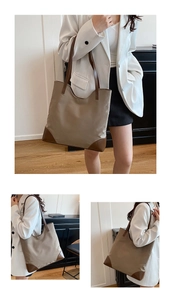Detail of a beige canvas tote bag with brown leather trim and reinforced bottom corners