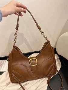 Vintage caramel hobo shoulder bag with large gold buckle and chain strap detail