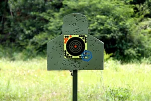 Close-up of adhesive shooting targets on a dark board with realistic bullet hole effects