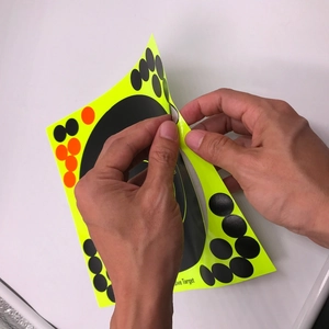 Adhesive shooting target sticker set with high contrast neon yellow and black bullseye
