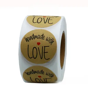Macro detail of 1 inch round Kraft paper stickers with handmade with love logo and heart