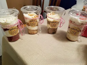 Detail of round kraft 'Handmade with LOVE' stickers on dessert cups with red cotton twine