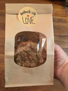 Detail of kraft paper food bag with handmade with love sticker and oval window
