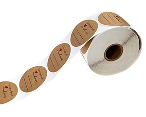 Macro view of oval Kraft paper stickers with 'homemade with love' text and writing lines