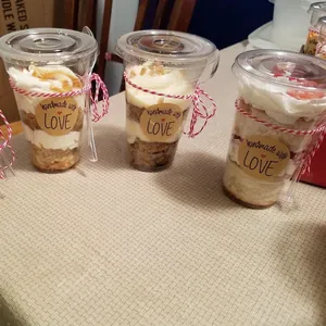 Roll of Kraft paper Thank You stickers on dessert cups with twine and plastic spoons
