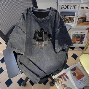 Close-up of vintage washed charcoal cotton t-shirt featuring cat group prints