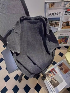 Women oversized vintage washed cotton T-shirt in dark charcoal grey shown on a chair