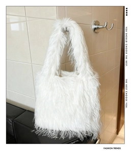 Detail of white faux fur tote bag showing the fluffy texture and plush material