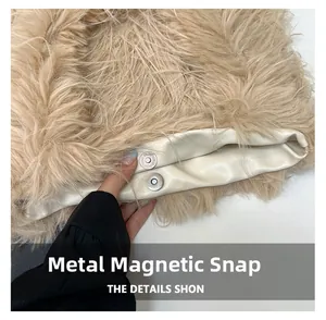 Macro shot of hidden magnetic hardware closure on a beige plush faux fur tote bag